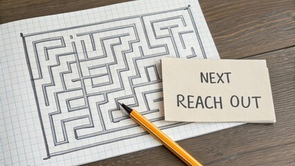 Handwritten Maze Puzzle with Note for Next Steps on Wood Table