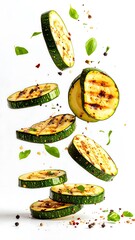 Grilled zucchini slices in mid-air, seasoned