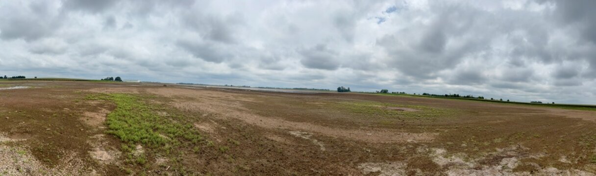 panoramic view of an empty fallow field on a gray day
