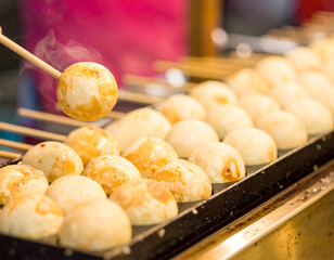 Steaming Takoyaki Balls on Grill with Wooden Skewer, Street Food