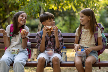 Children enjoying lunch break in park during school time