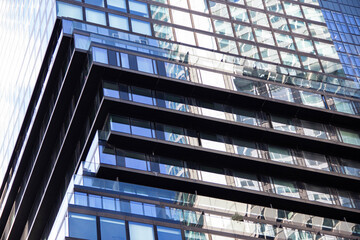 Modern architectural design featuring sleek glass and steel elements, showcasing a dynamic interplay of light and shadow in an urban environment with contemporary aesthetics