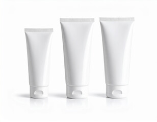 Three White Cosmetic Tubes in Varying Sizes on White Background,