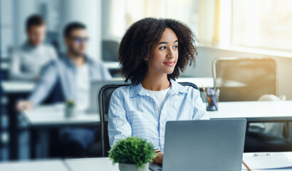Business process and management ideas creation. African american woman looking at window at...