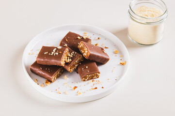 Chocolate nut protein bars on a plate on a table