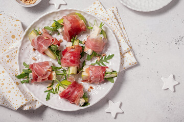 Appetizer with pear, blue cheese and prosciutto ham for holidays