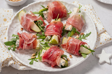 Appetizer with pear, blue cheese and prosciutto ham for holidays