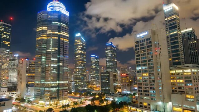 The skyline of major financial district within densely populated metropolitan area in Southeast Asian country, illuminated during nighttime hours