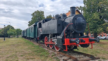 Fototapeta premium Old steam locomotive on display outdoors