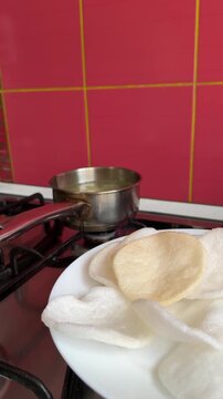 Banh Phong Tom Vietnamese Shrimp Chips Deep Fry Prawn Crackers in oil in a frying pan - Oriental fried prawn crisps and used with sweet chilli sauce dip.