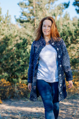 Female portrait. Beautiful young girl with long dark hair on a sunny autumn day outdoors. Vertical photo. High quality photo