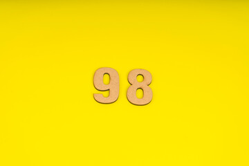 Number ninety-eight on yellow background