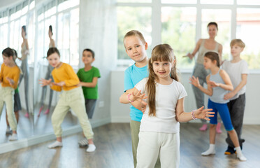 Girl paired up with boy and training to perform active boogie woogie couple dance, rehearse performance. Devotion of modern trend pastime, active lifestyle and hobbies