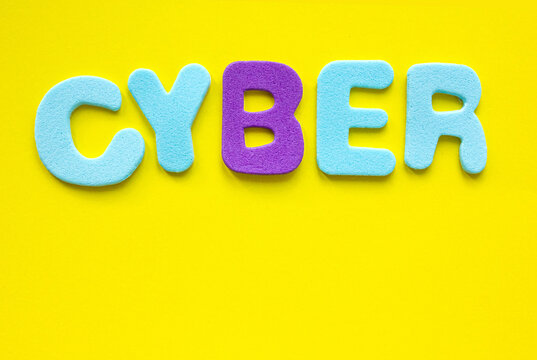 Cyber text with copy space on yellow background, flat lay.