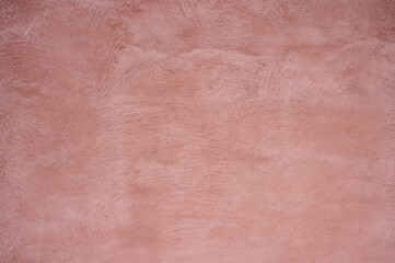 A smooth pink wall showcases a soft, textured surface with natural variations in color and depth, ideal for enhancing contemporary living spaces in residential areas