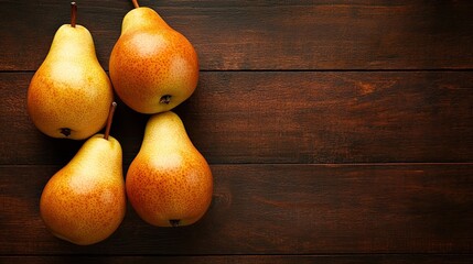 Four ripe pears on dark wood background