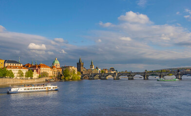 Charles Bridge (Karluv Most) on Vltava river and Old Town Bridge Tower, famous tourist destination in Prague, Czech Republic (Czechia), at sunset