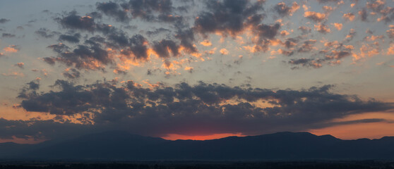Sunset over the Balkans. The stillness and the dusk. Cirrus clouds in a crimson sky.
