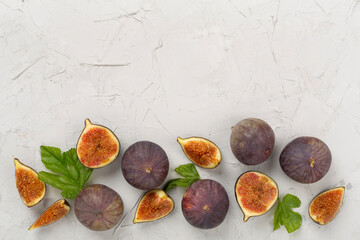 Fresh tasty fig fruits on concrete background, top view