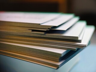 Stack of White Paper Sheets CloseUp on Table.