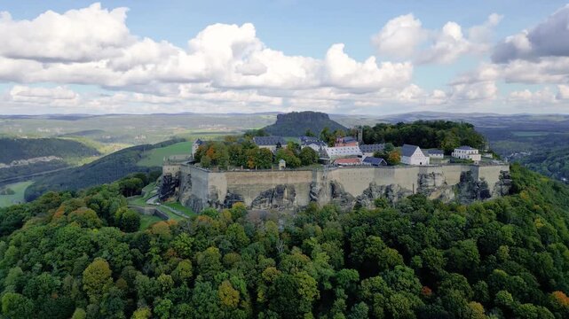 Aerial view of Festung Koenigstein in Saxon Switzerland, Saxony, Germany, with Elbe River and forest. Shot on October 23, 2023.