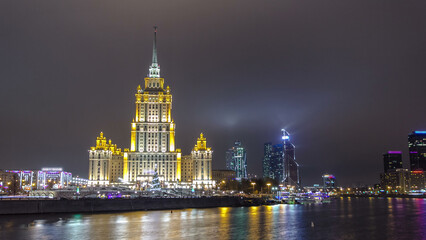 Obraz premium Hotel Ukraine winter night timelapse hyperlapse with bridge over Moscow River.