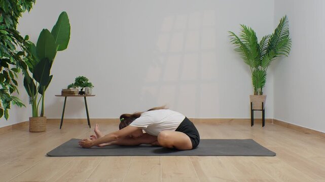 High-definition footage of a female instructor performing a variety of full-body yoga poses on a bright, neutral backdrop. Clean, minimalist composition and soft studio lighting highlight balance, fle