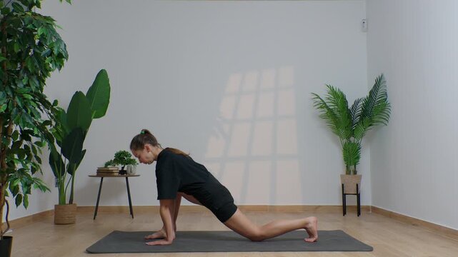 High-definition footage of a female instructor performing a variety of full-body yoga poses on a bright, neutral backdrop. Clean, minimalist composition and soft studio lighting highlight balance, fle