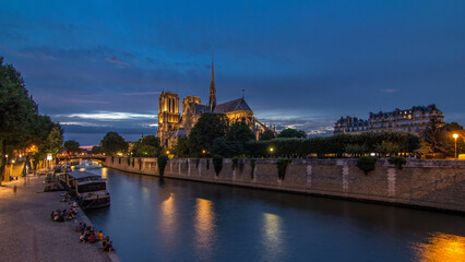Fototapeta premium Cathedral Notre Dame de Paris day to night timelapse after sunset in Paris, France.