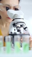 Woman scientist using microscope in laboratory. Microbiology science concept