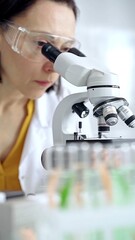 Woman scientist using microscope in laboratory. Microbiology science concept