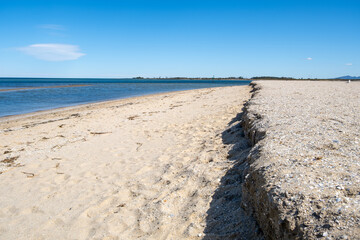 The erosion at Werribee South Beach with a sharp edge or “scarp” along the shoreline. Concept of coastal erosion, climate impact, and environmental change in Melbourne, Australia.