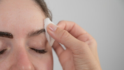 Caucasian woman getting eyebrow tinting procedure. 
