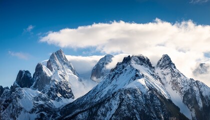 A Mountain Range Covered In Snow And Clouds The Sky Is Blue And The Clouds Are White The Mountain Range Is Very Tall And Majestic