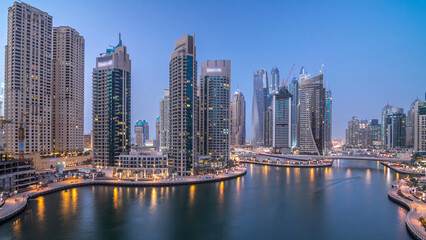 Fototapeta premium Beautiful aerial top view day to night transition timelapse of Dubai Marina canal