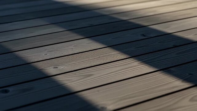 Artistic medium frame capturing shadow line geometry and pronounced grain detail on pristine lowangle terrace decking.