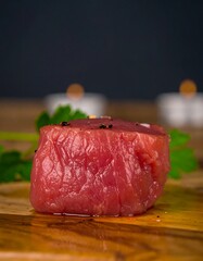 Fresh raw beef tenderloin on wooden cutting board