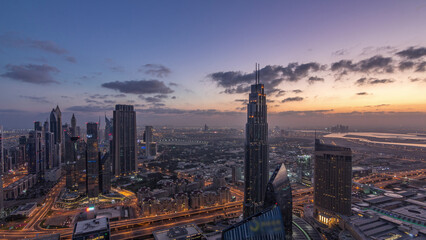 Obraz premium Dubai International Financial Centre district with modern skyscrapers night to day timelapse