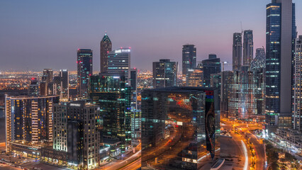Obraz premium Dubai's business bay towers at evening aerial day to night timelapse.