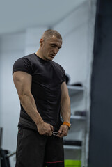 athletic man executes squats in a gym setting prioritizing technique and strength. His focus...
