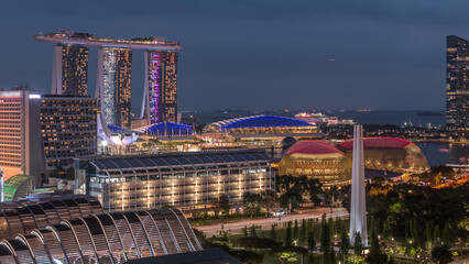 Fototapeta premium Evening panorama with Marina Bay area and skyscrapers city skyline aerial day to night timelapse.