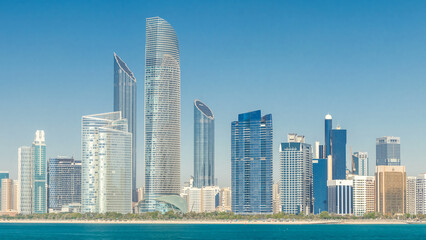Obraz premium View of high skyscrapers on a corniche in Abu Dhabi stretching alongside the business center timelapse.