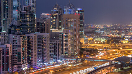 Fototapeta premium Dubai marina with traffic on sheikh zayed road panorama day to night timelapse lights turn on.
