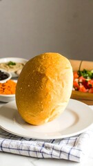 Freshly Baked Bread on Plate with Colorful Sides