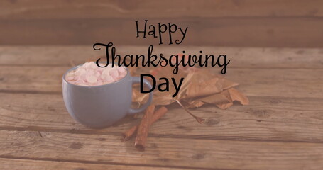 Image of happy thanksgiving day text over mug with hot chocolate on wooden background