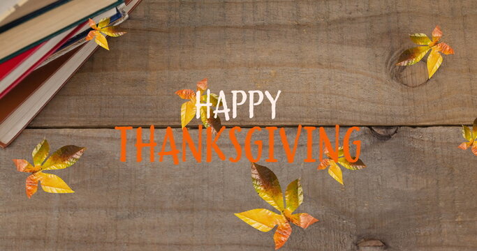 Fototapeta Image of happy thanksgiving text over autumn leaves on wooden background