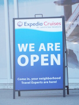 Ottawa, ON, Canada, June 18, 2025: A close-up of a black A-frame sign for "Expedia Cruises" on Iris Street.
