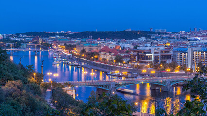 Aerial evening view of the Vltava River and illuminated bridges day to night timelapse, Prague