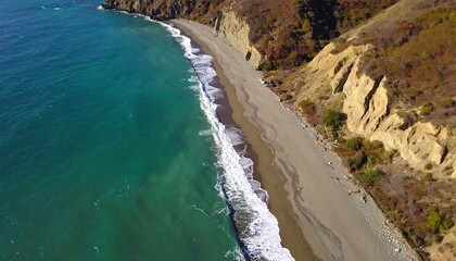 Obraz premium Aerial view of a serene beach with gentle waves