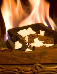 Warm glow of fire with coconut flakes in fireplace